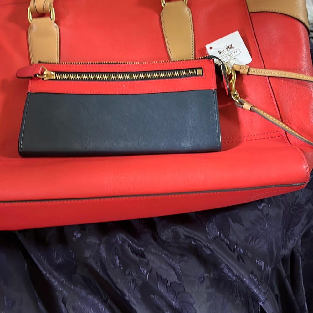 Coach Wristlet in Navy/ Red with Tan removable wrist wrap. Accentuated in Gold.